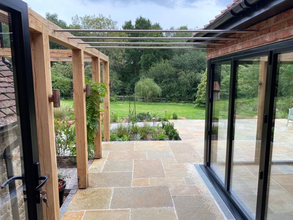 new entertaining space with matching flooring on block and beam patio by RM Construction